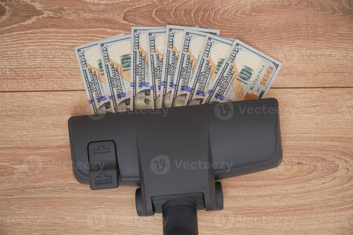 Vacuum cleaner suck usd dollar banknotes. Launder money concept photo