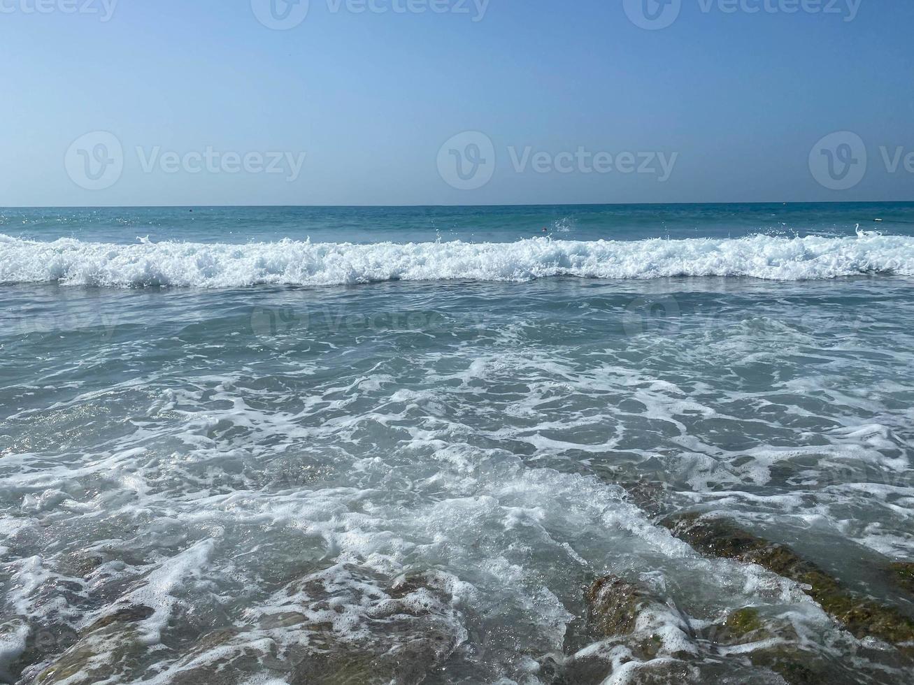 Beautiful sea with waves splashing water landscape view from the beach in a warm tropical eastern country southern resort. Background, texture photo