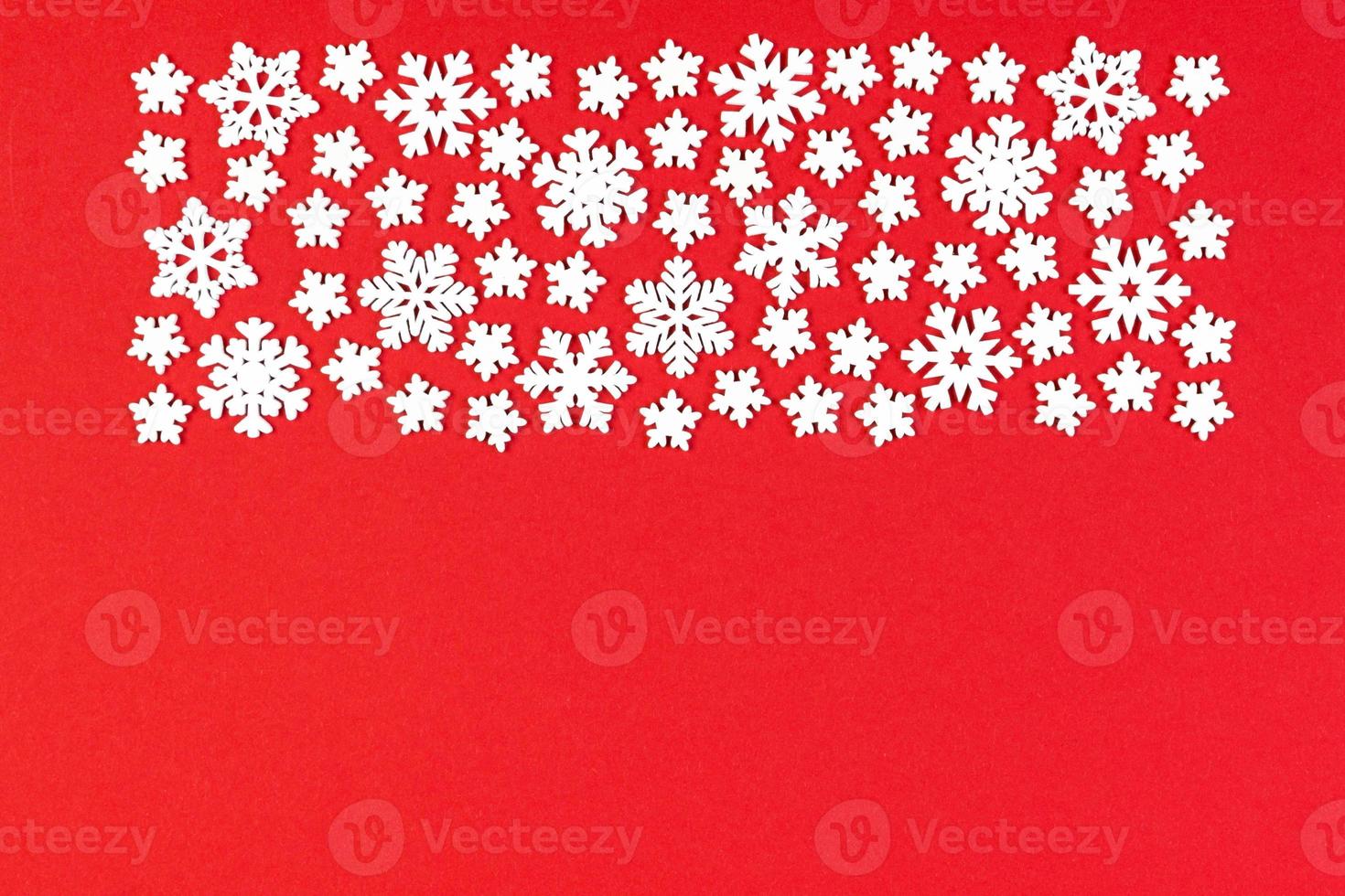 Top view of white snowflakes on colorful background. Winter weather concept with copy space. Merry Christmas concept photo