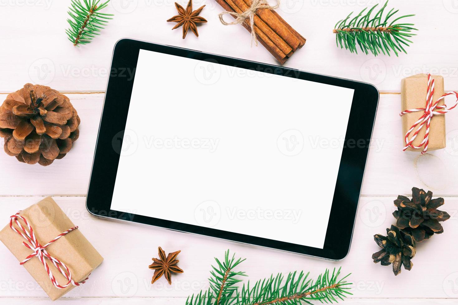 Digital tablet mock up with rustic Christmas wooden background decorations for app presentation. top view with copy space. Toned photo