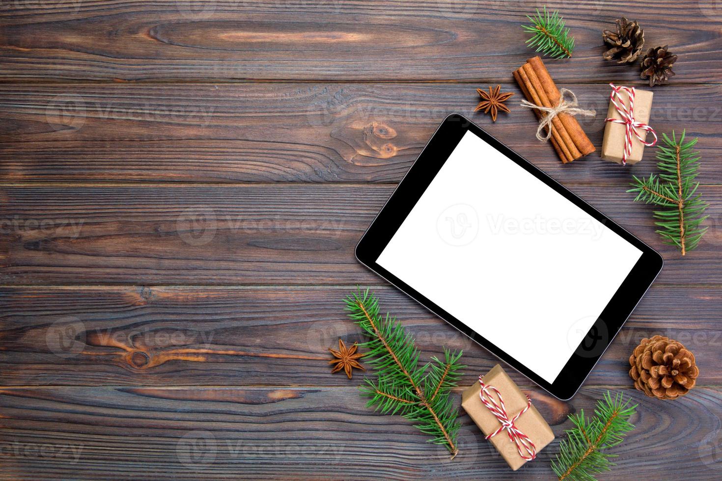 Digital tablet mock up with rustic Christmas wooden background decorations for app presentation. top view with copy space photo