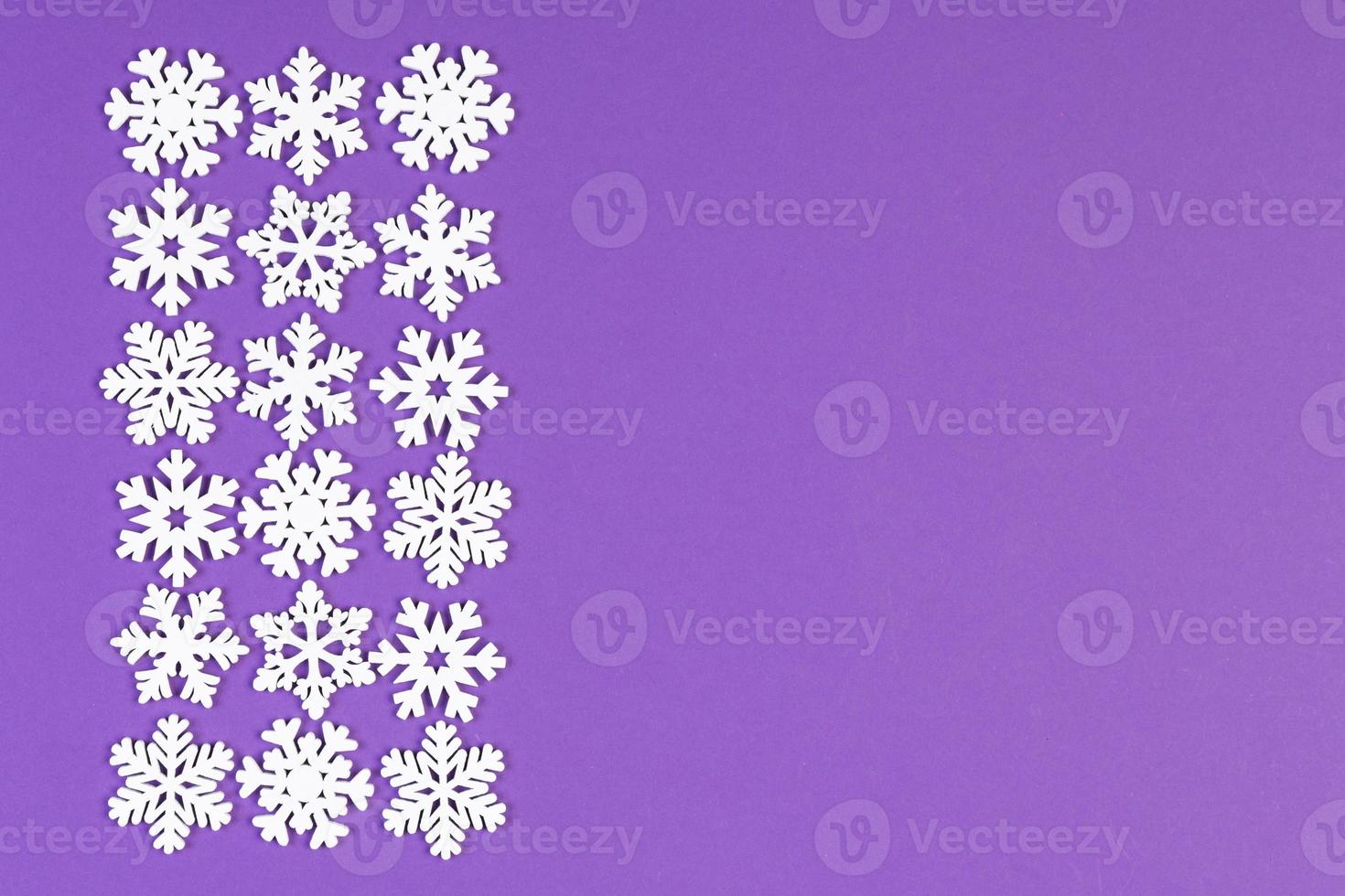 Set of white snowflakes on colorful background. Top view of Christmas ornament. New Year time concept with empty space for your design photo