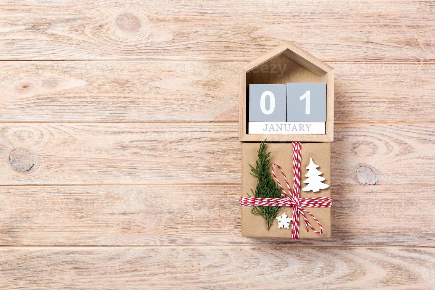 Calendar with date 1 january and gift boxes on color background. Christmas concept photo