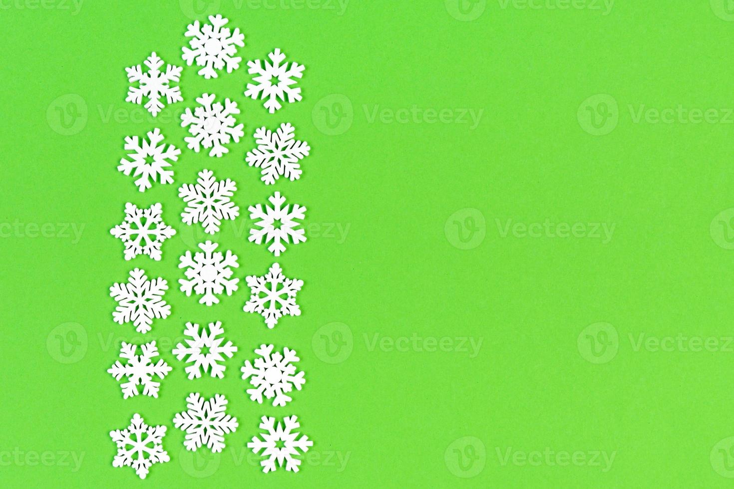 Top view of white snowflakes on colorful background. Winter weather concept with copy space. Merry Christmas concept photo