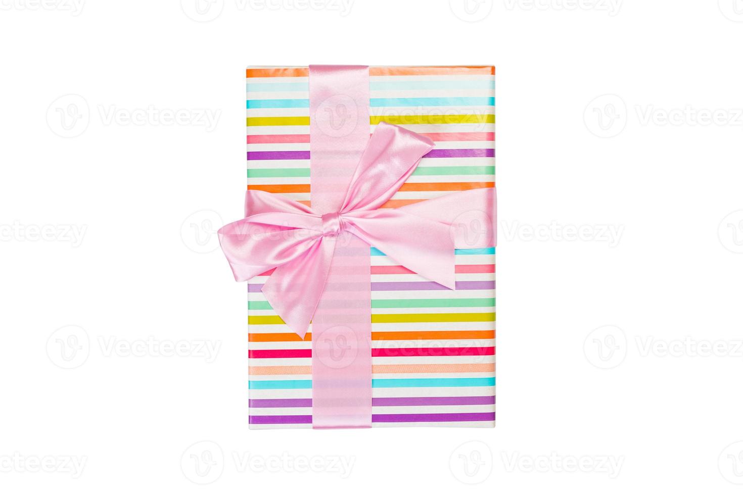 Christmas or other holiday handmade present in colored paper with pink ribbon. Isolated on white background, top view. thanksgiving Gift box concept photo