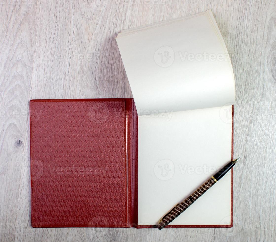 Open Notebook With White Pages And Gold Fountain Pen photo