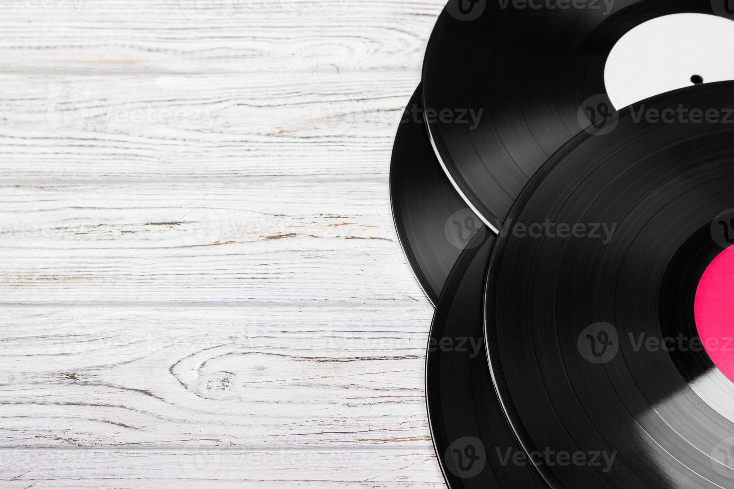 Old vinyl record on the bright wooden table, selective focus and toned image. Copy space photo