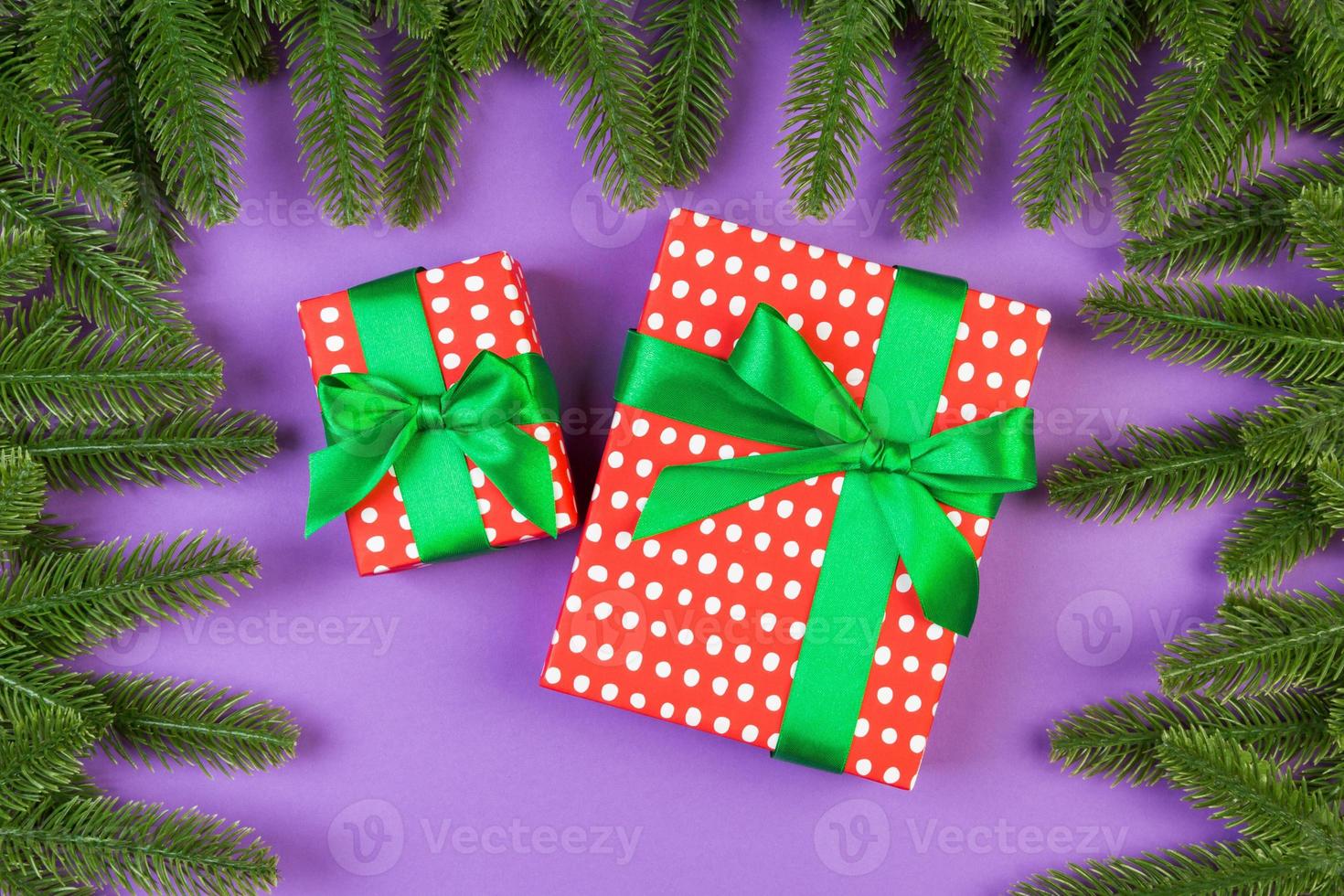 Top view of gift box and fir tree branches on colorful background. Merry Christmas concept with empty space for your design photo