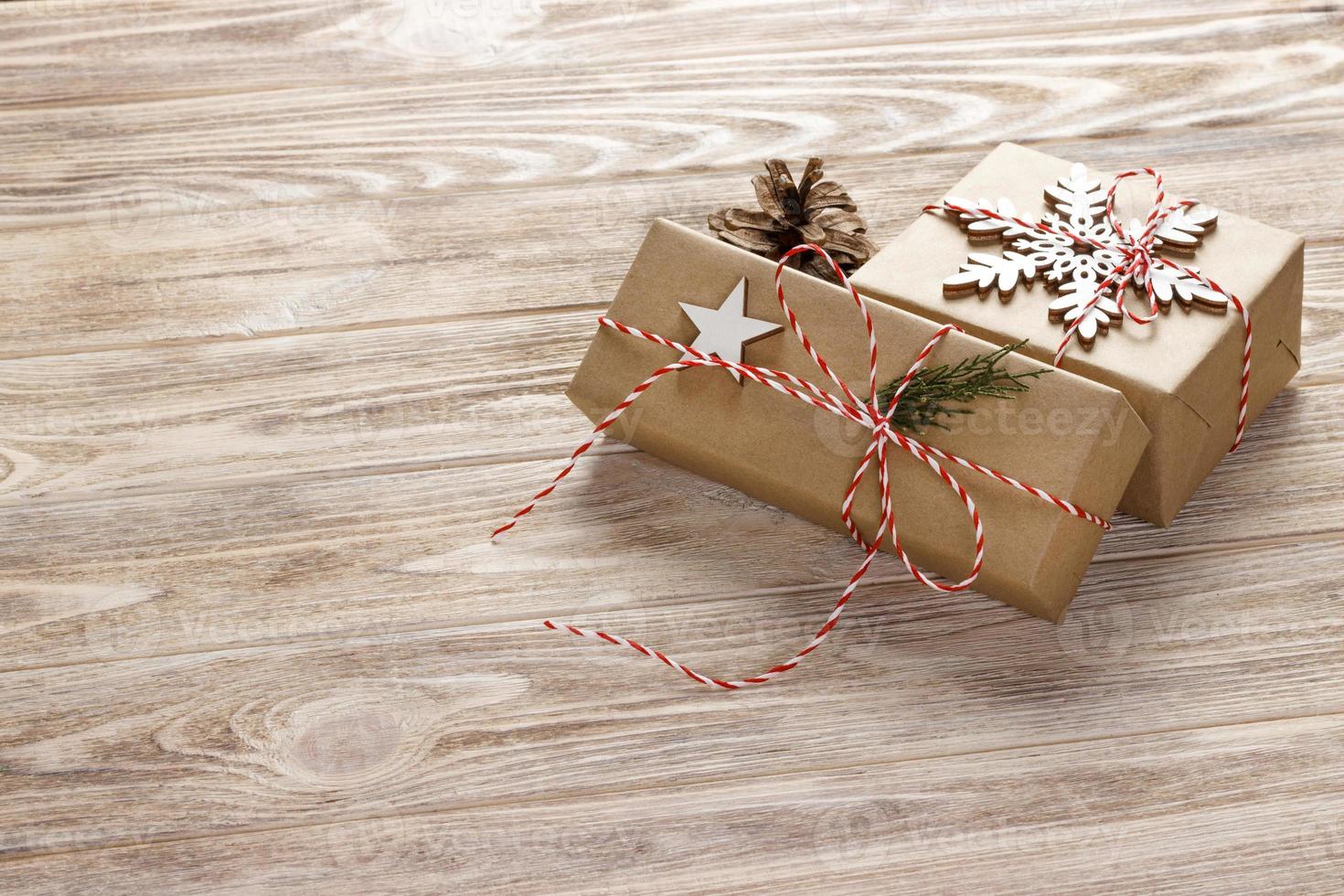 Christmas gift boxes on wooden table with snowflake. Top view with copy space photo