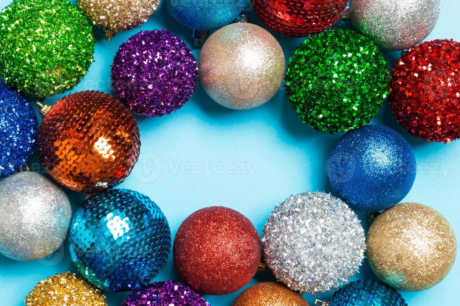 Top view of frame made of decorative balls on colorful background. Christmas toys concept with empty space for your design photo