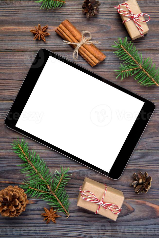 Digital tablet mock up with rustic Christmas wooden background decorations for app presentation. top view with copy space photo