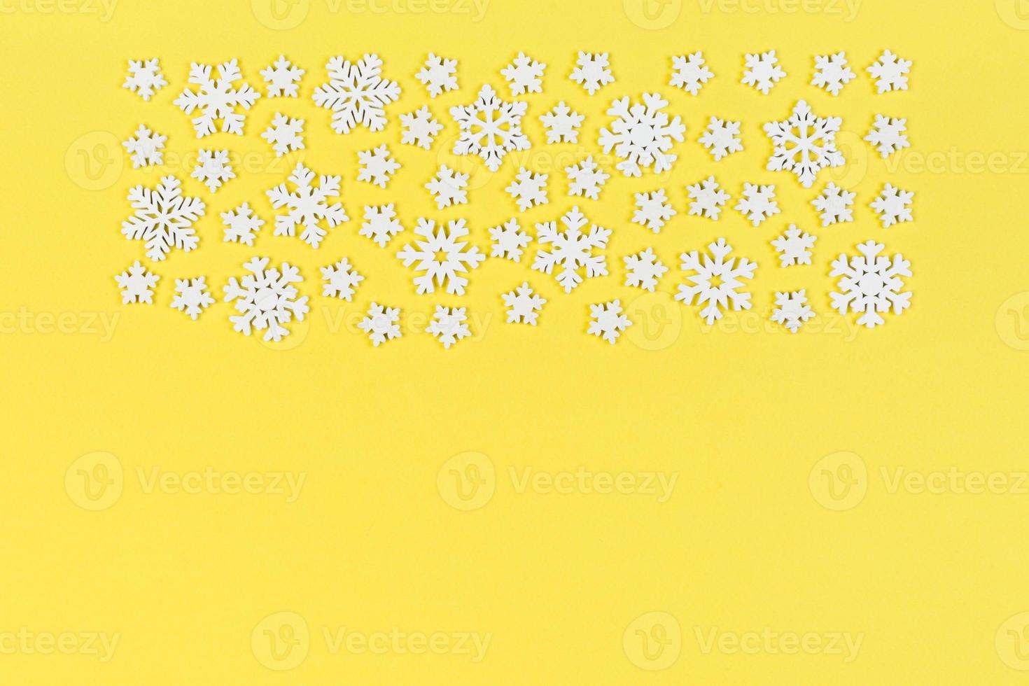 Top view of white snowflakes on colorful background. Winter weather concept with copy space. Merry Christmas concept photo