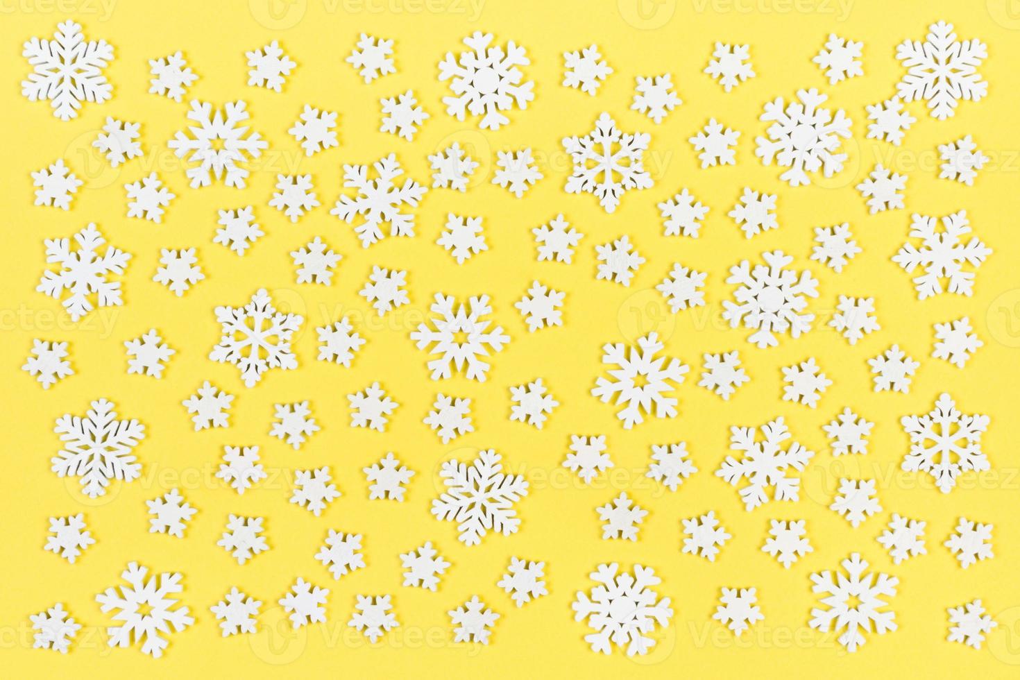 Top view of white snowflakes on colorful background. Winter weather concept with copy space. Merry Christmas concept photo