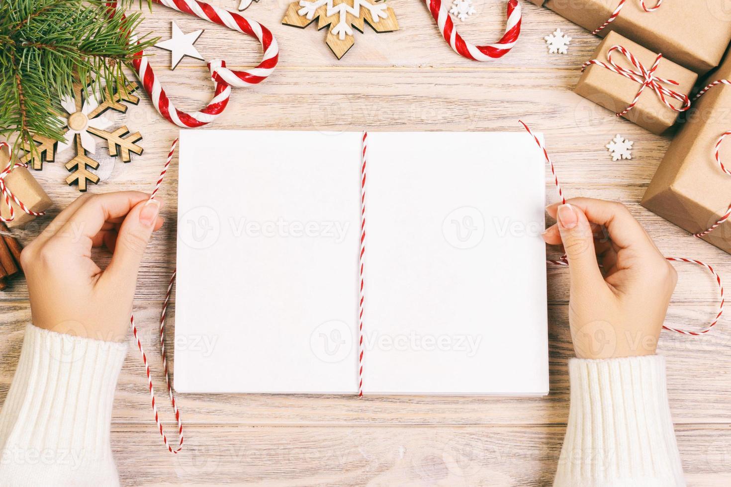 girl tie Christmas letters in envelope, children santa claus letter in envelope, christmas background. Toned photo