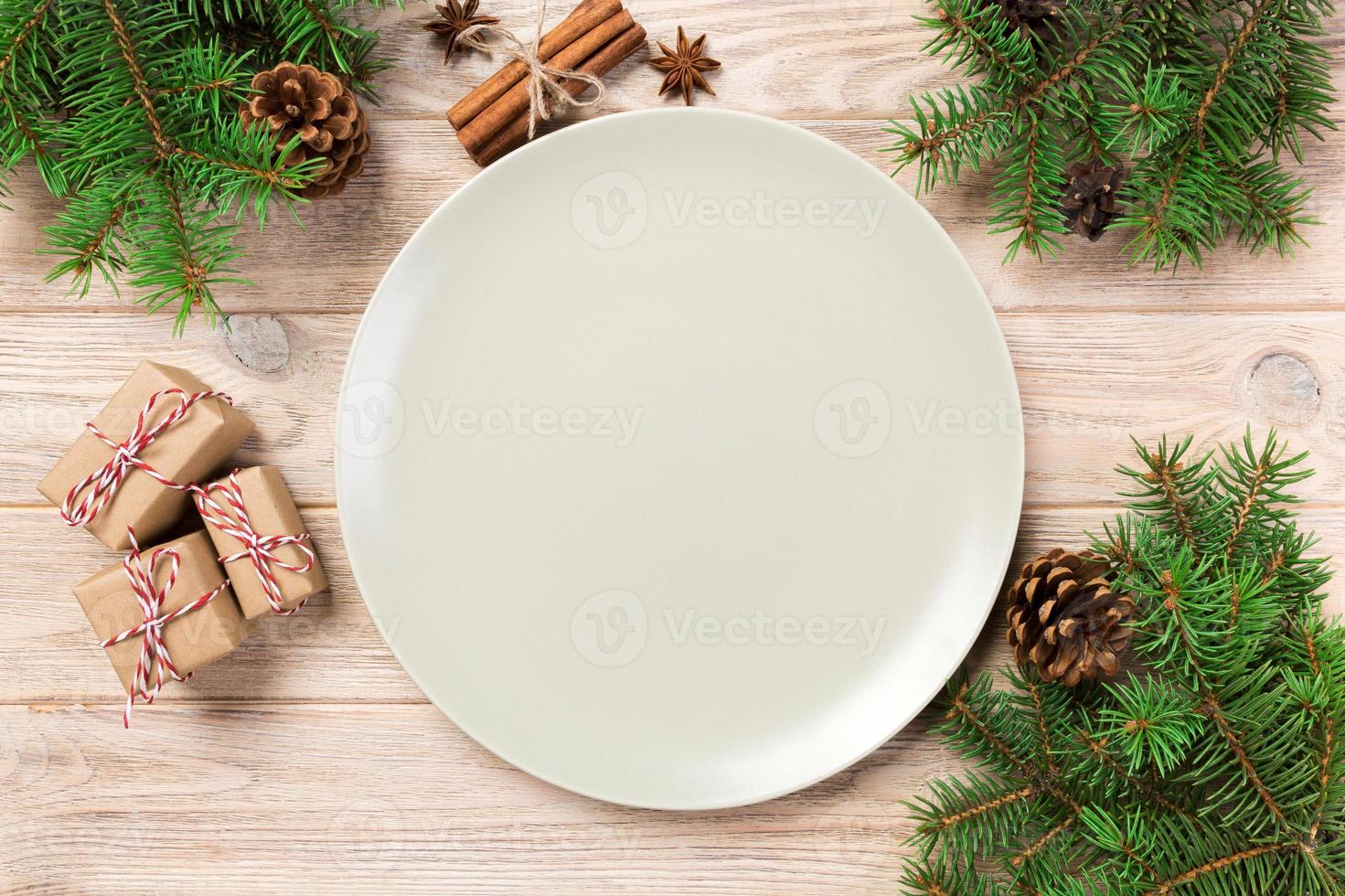 Empty white matte plate on wooden background with christmas decoration, Round dish. New Year concept photo