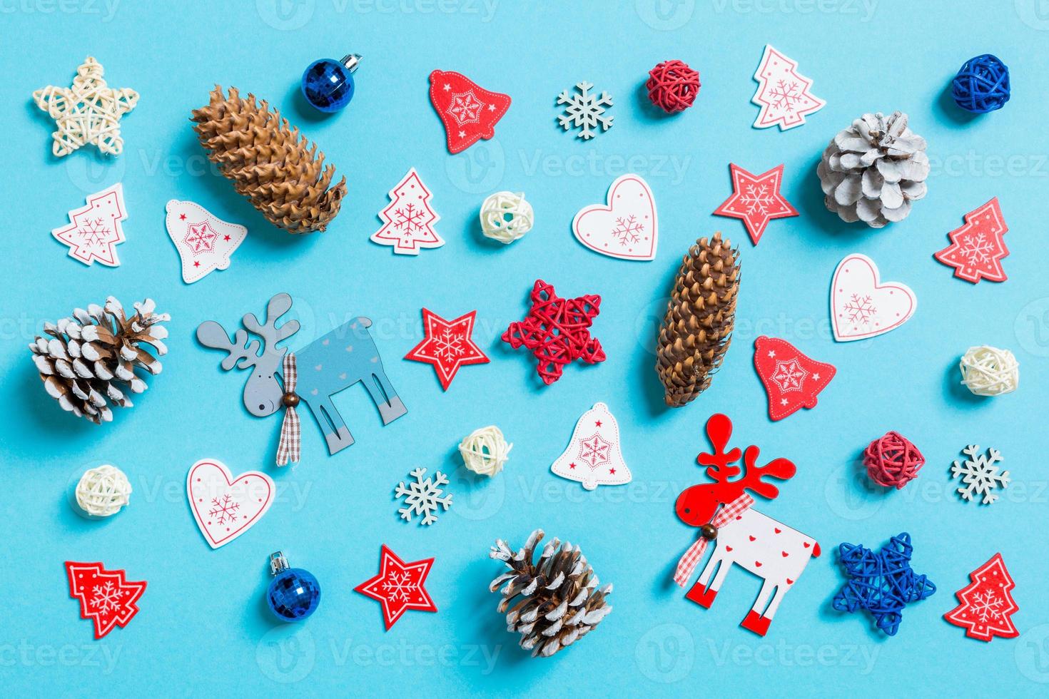 vista superior de los juguetes y decoraciones de año nuevo sobre fondo azul. concepto de tiempo de navidad foto