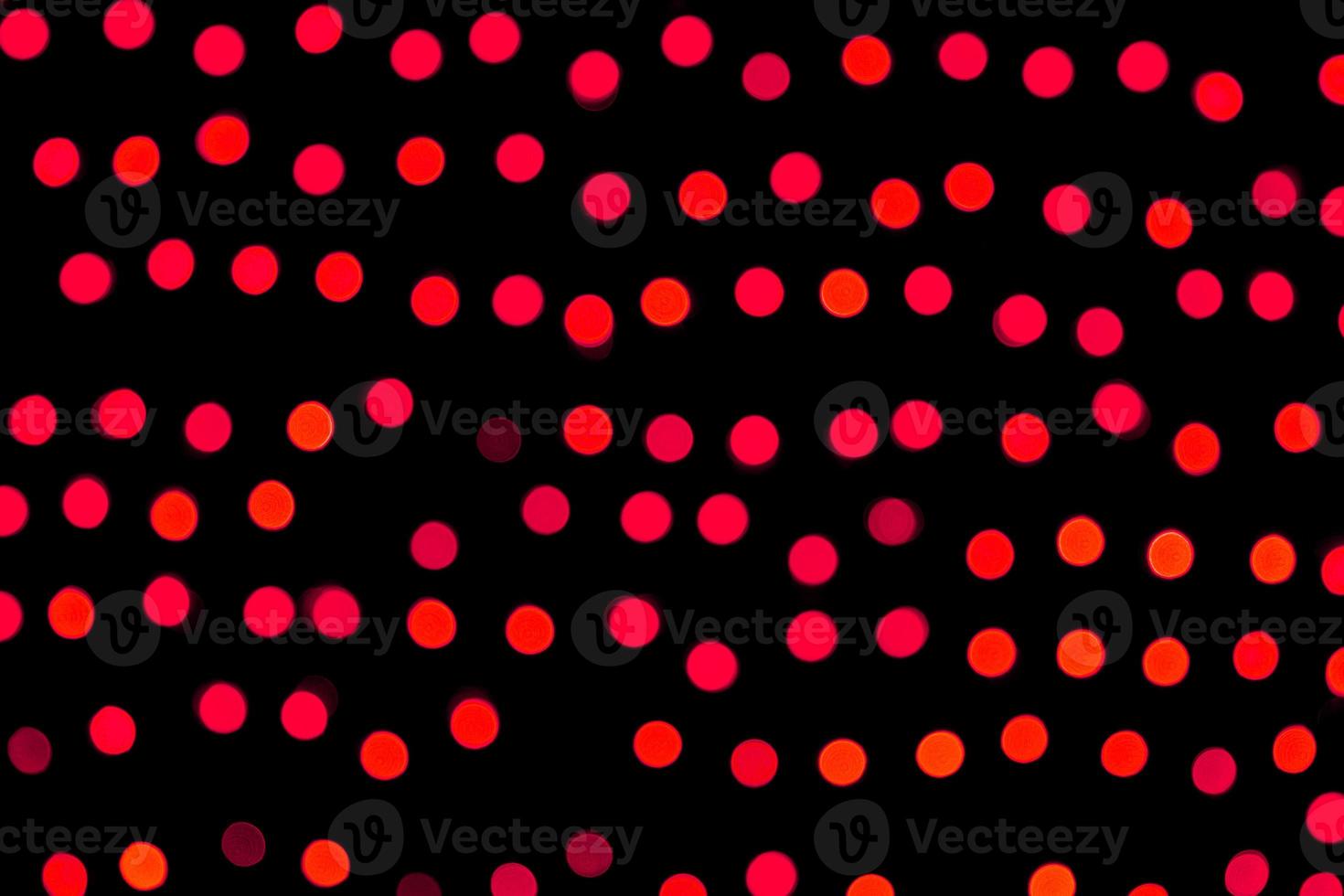 Unfocused abstract red bokeh on black background. defocused and blurred many round light photo