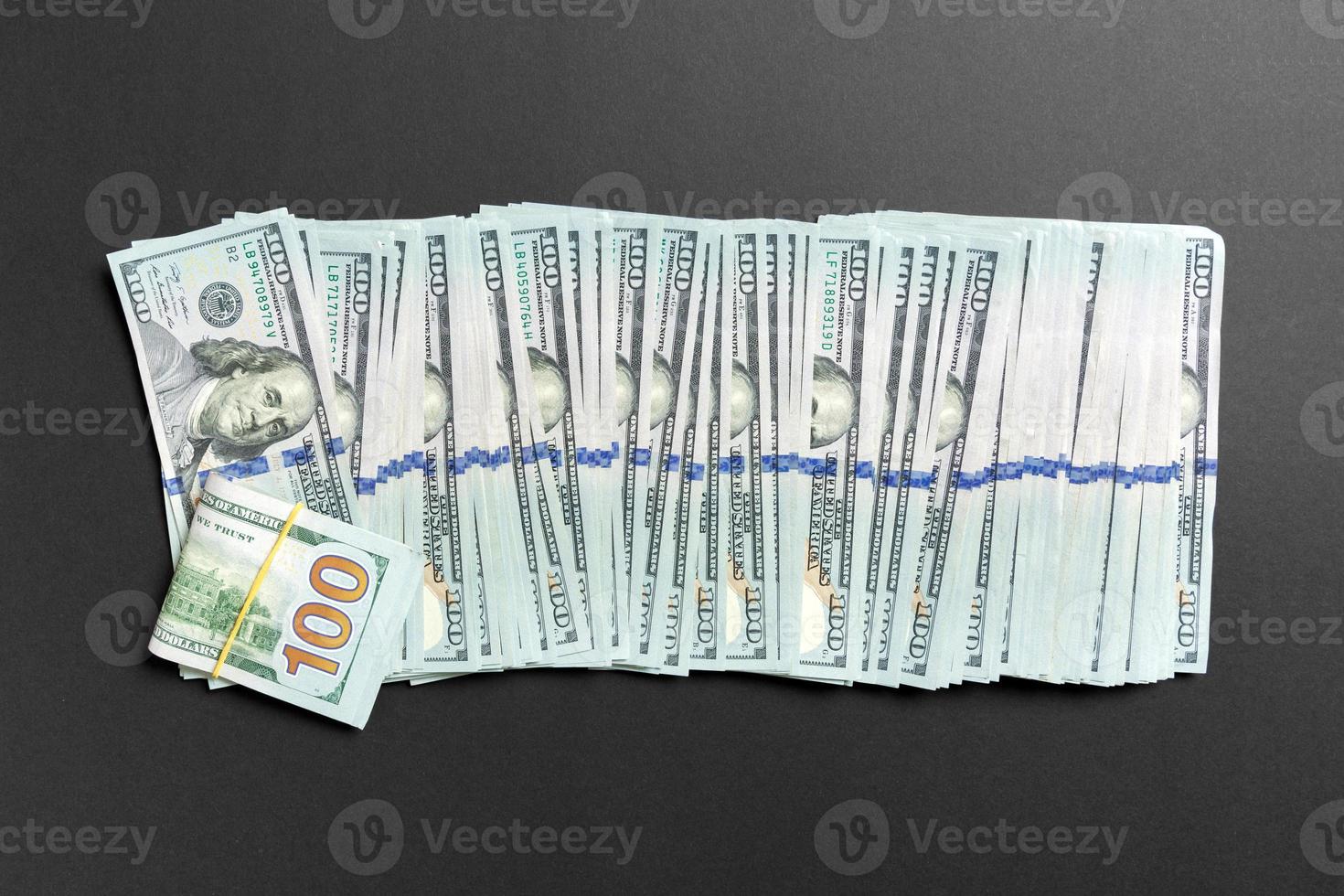 Top view of lying 100 dollar banknotes in one line on colorful background. Close up of money saving concept photo