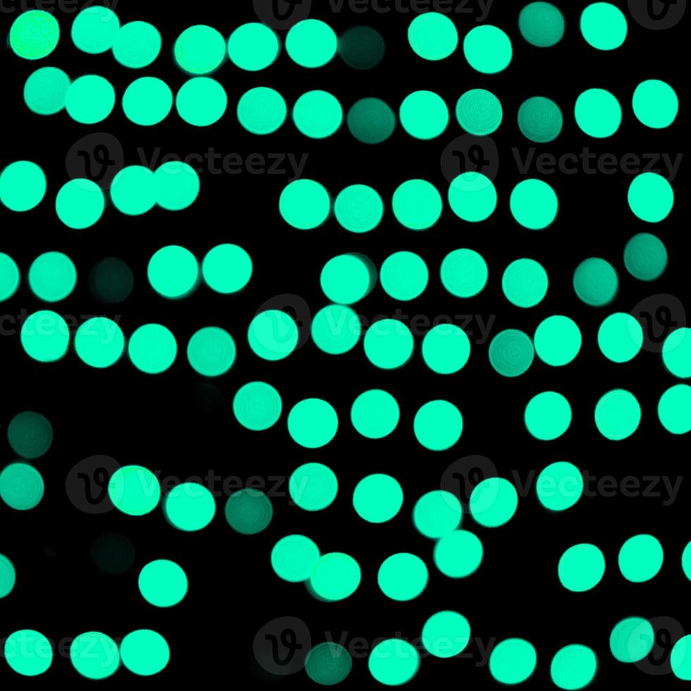 Unfocused abstract colourful bokeh black background. defocused and blurred many round blue light photo