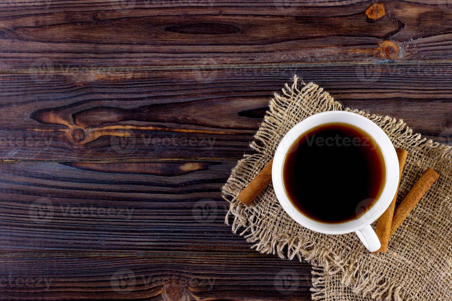 Coffee cup on wooden table texture. View from above photo