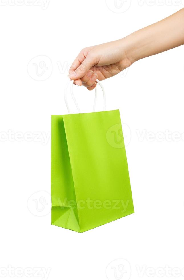 Hand with green bag isolated on white background photo