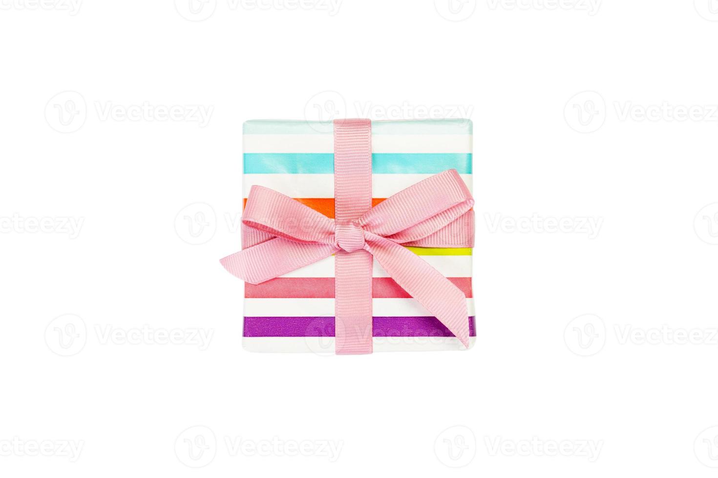 Christmas or other holiday handmade present in colored paper with pink ribbon. Isolated on white background, top view. thanksgiving Gift box concept photo