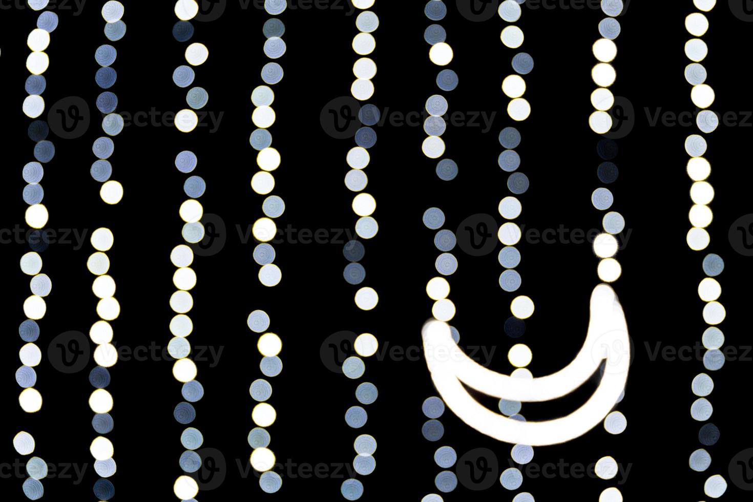 Abstract bokeh of white city lights on black background. defocused and blurred with moon of lights photo