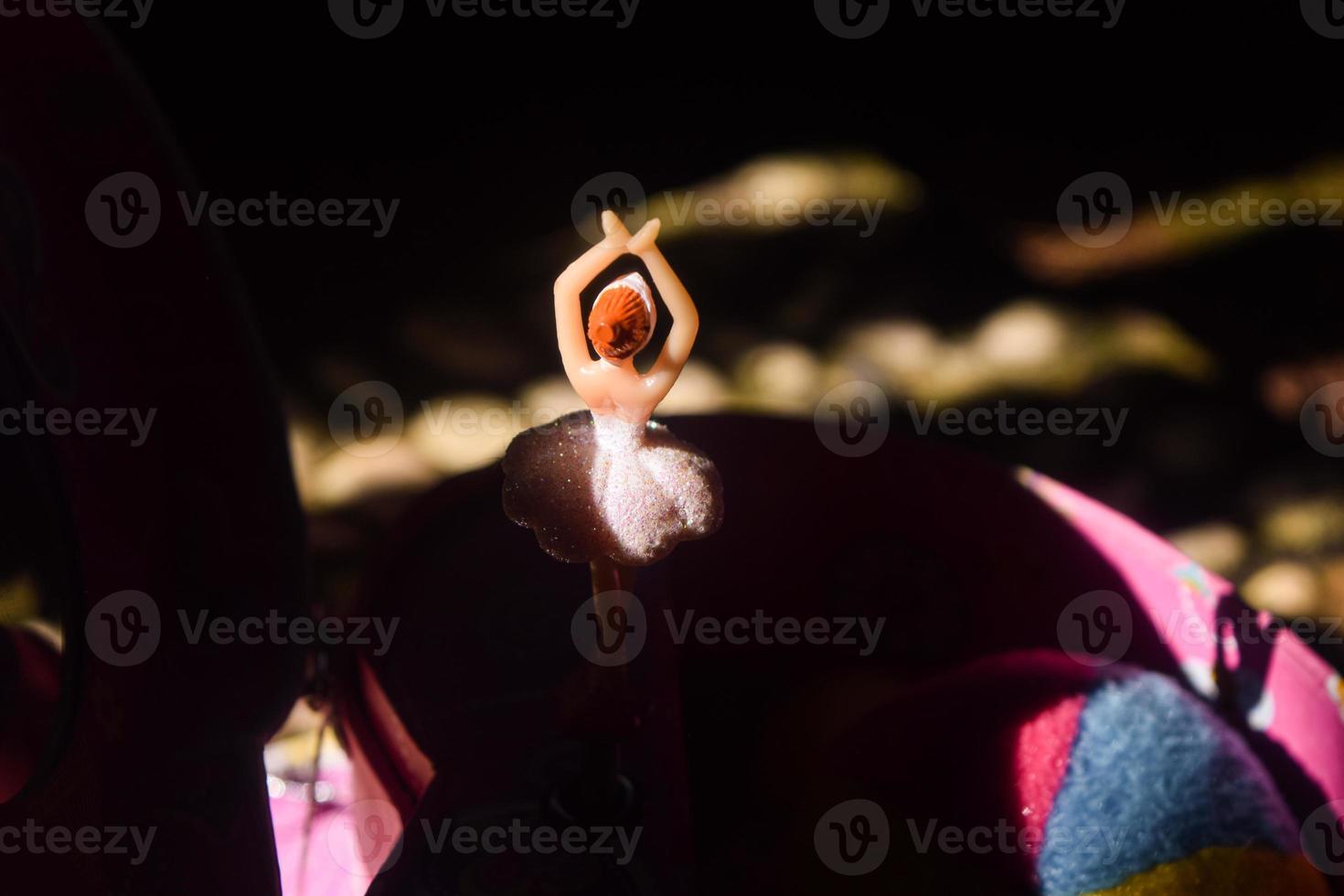 pink music box with ballerina figure in the shadow photo