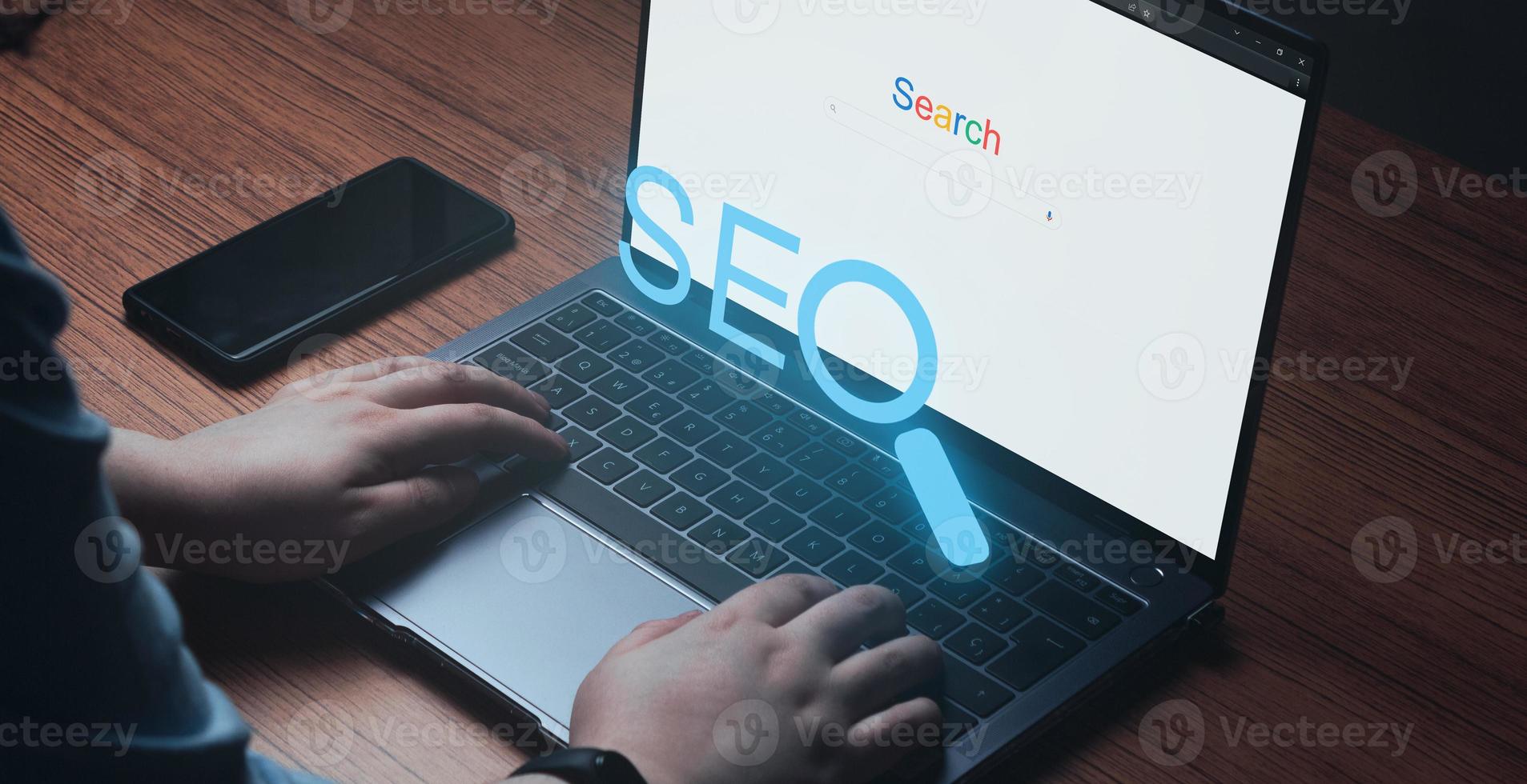 Woman using laptop with VR SEO text on keyboard. SEO Search Engine Optimization concept. Ranking traffic on website. Digital marketing business technology. photo