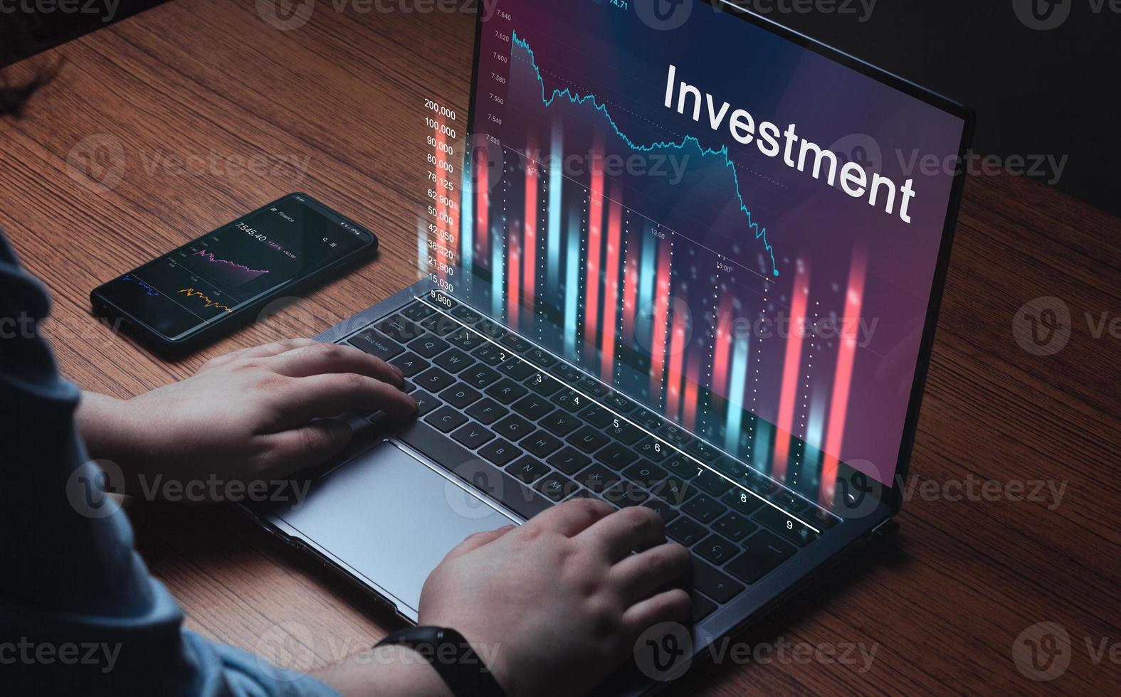 Young woman using laptop with financial stock market graph on laptop and smartphone. Concept business and financial investment. Forex chart. photo