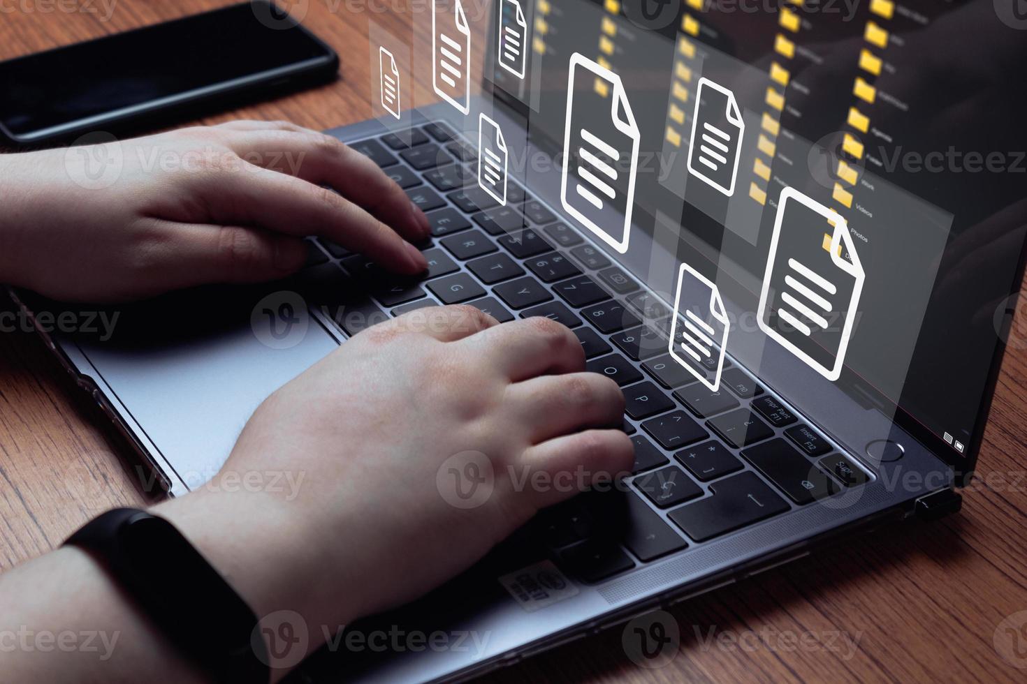 Woman use laptop with virtual holographic interface of documents. Document Management System DMS concept. Process automation to efficiently manage files. photo