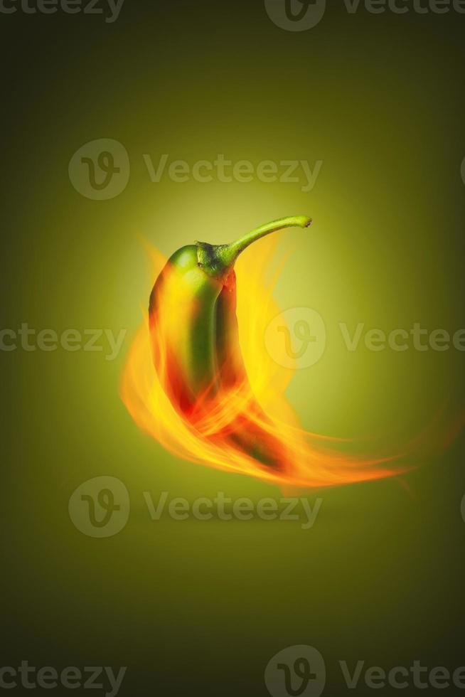 Vertical photo of spicy green pepper roasted on fire. Creative photo of hot jalapeno on fire for packaging and advertising. Food Design poster.