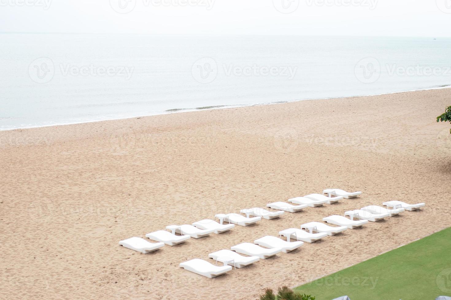 Lounge Chairs on sandy beach. photo