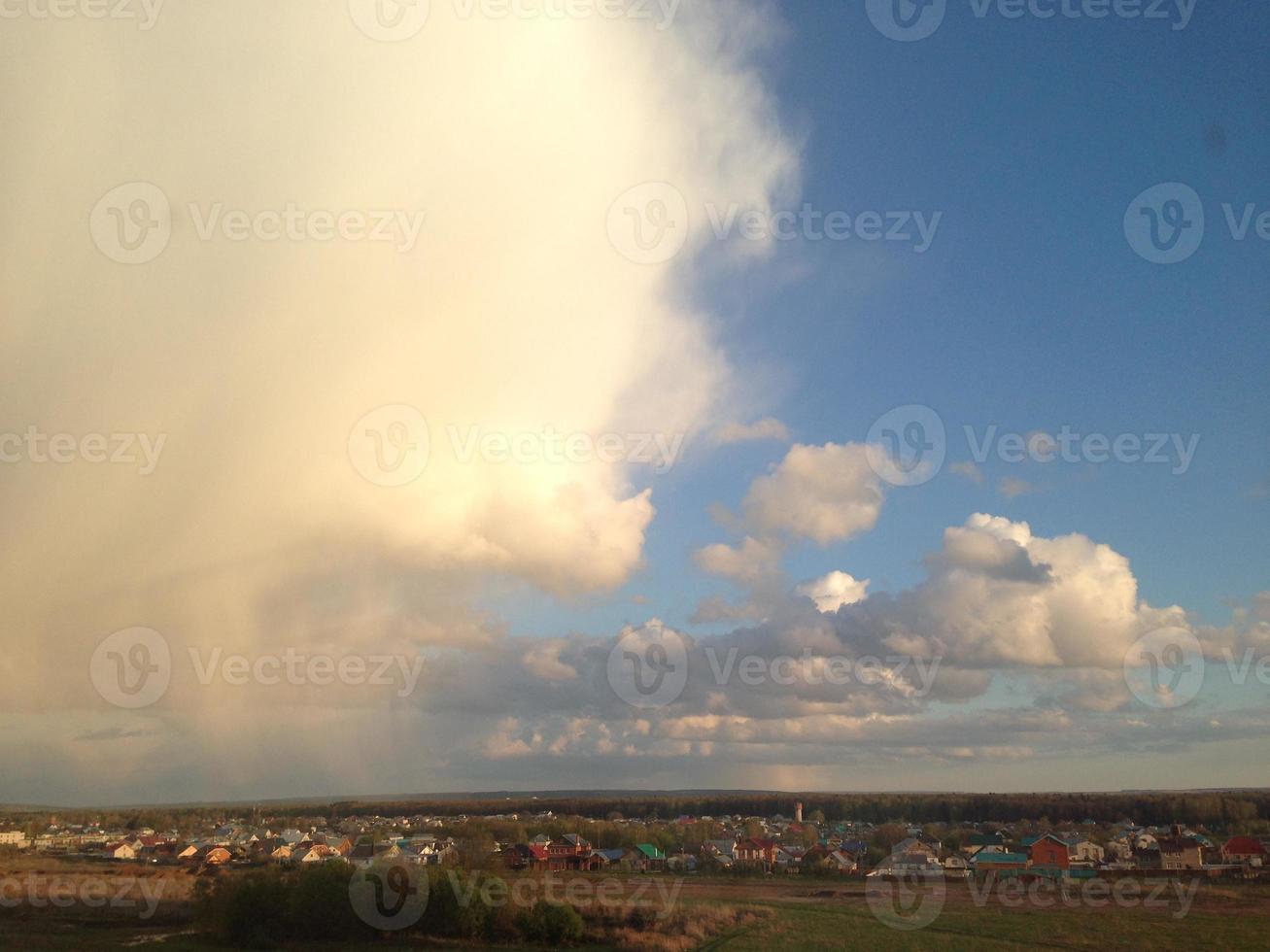 Huge clouds over the village. Sky before rain. photo