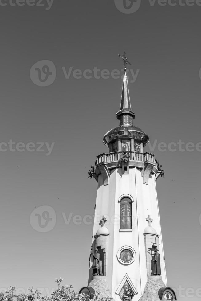Christian church cross in high steeple tower for prayer photo