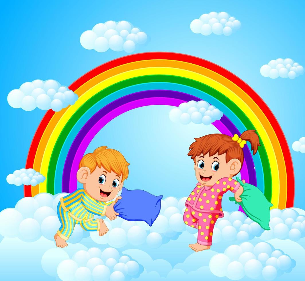 dos niños felices están luchando contra una almohada con un paisaje de arco iris vector