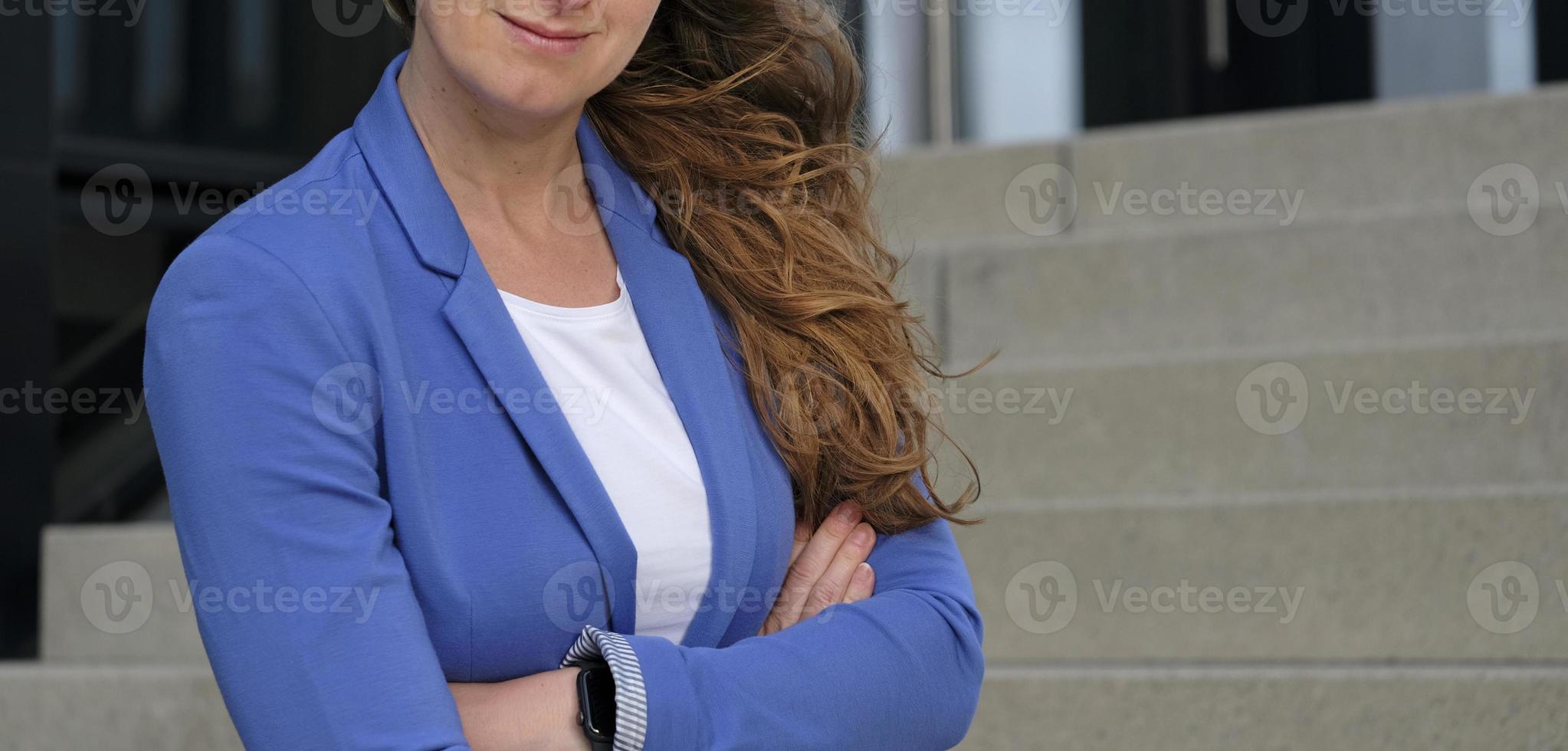 Female professional in a white shirt and blue suit jacket photo