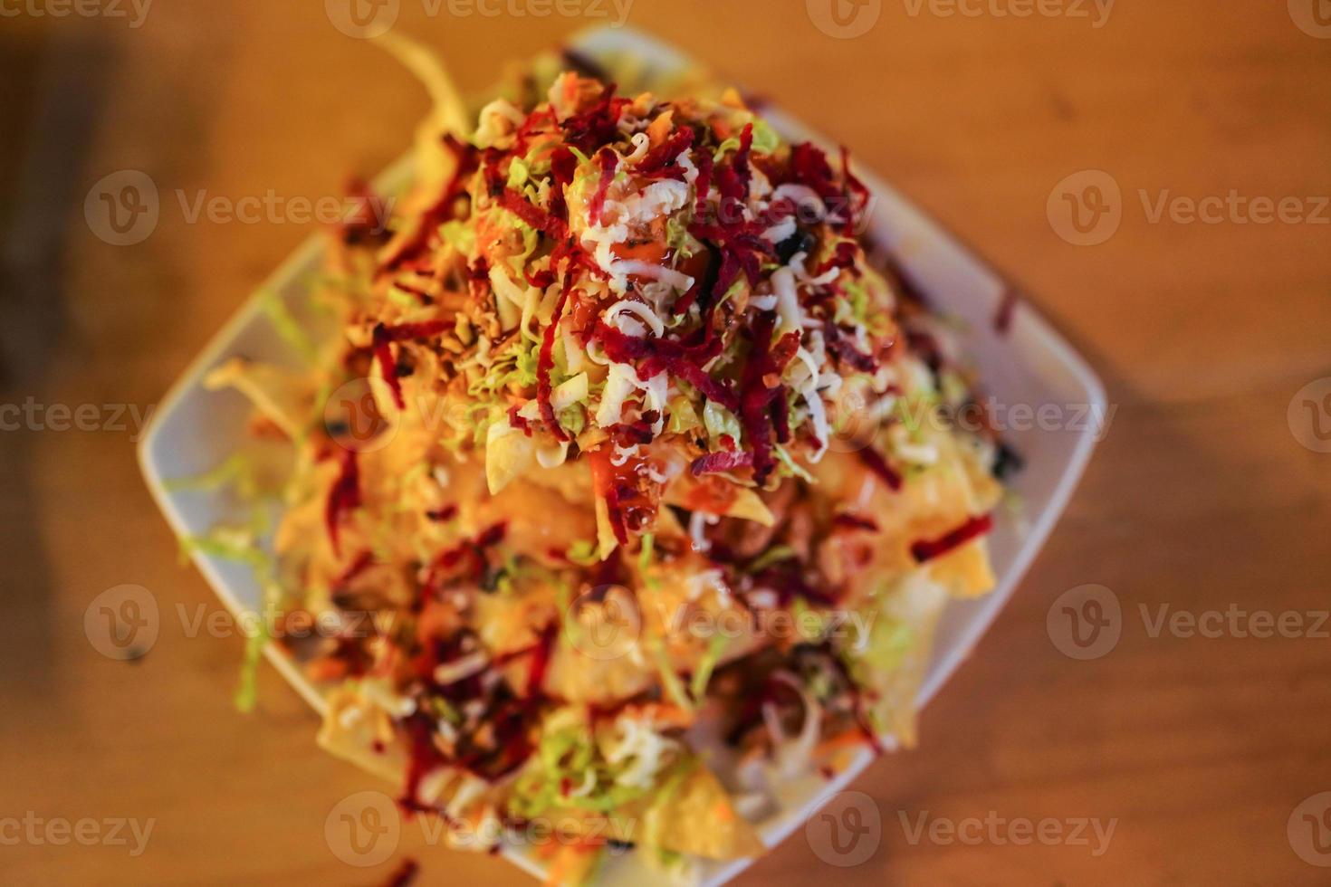 Cheese corn nachos served on a big plate ready to eat photo