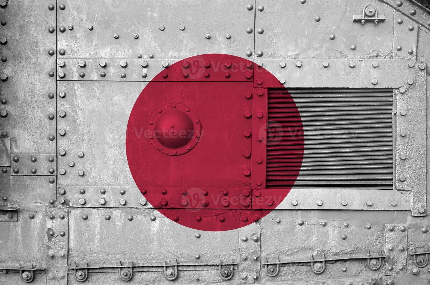 Japan flag depicted on side part of military armored tank closeup. Army forces conceptual background photo