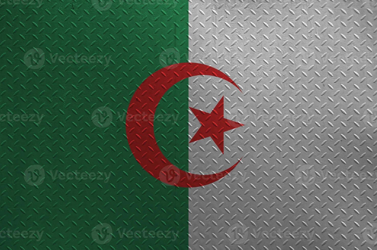 Algeria flag depicted in paint colors on old brushed metal plate or wall closeup. Textured banner on rough background photo