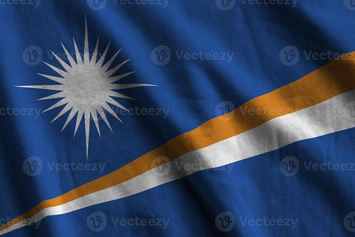 Marshall Islands flag with big folds waving close up under the studio light indoors. The official symbols and colors in banner photo