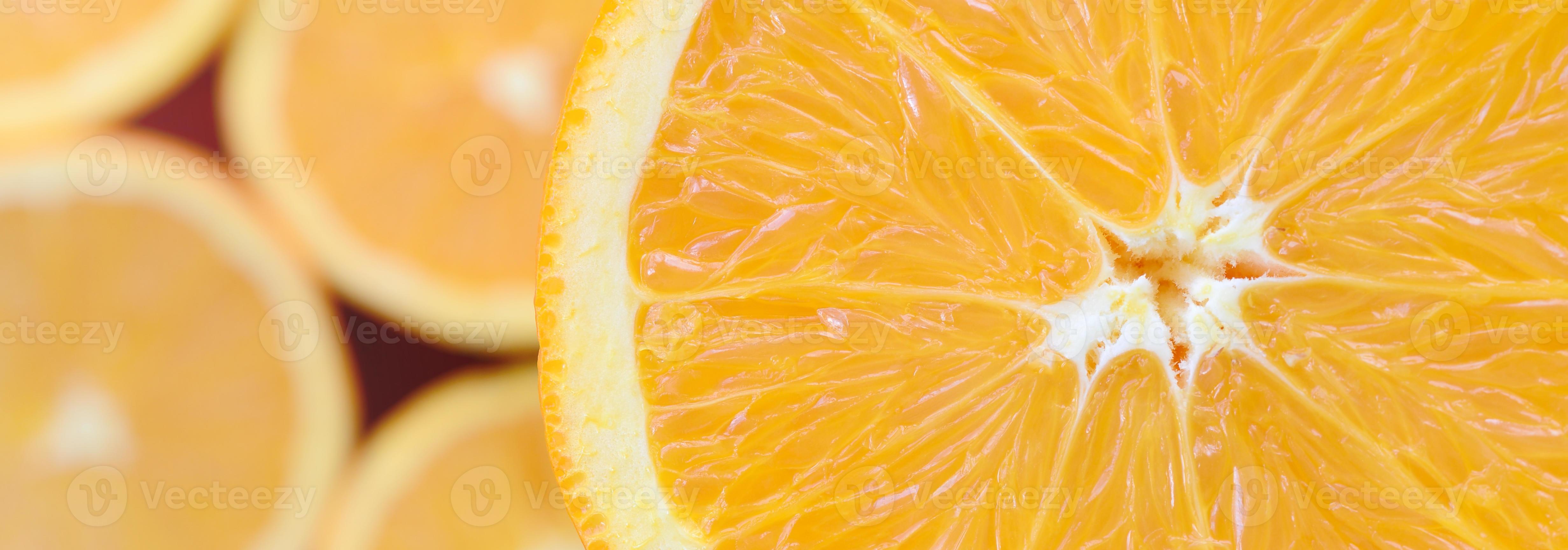 Top view of a fragment of the orange fruit slice on the background of