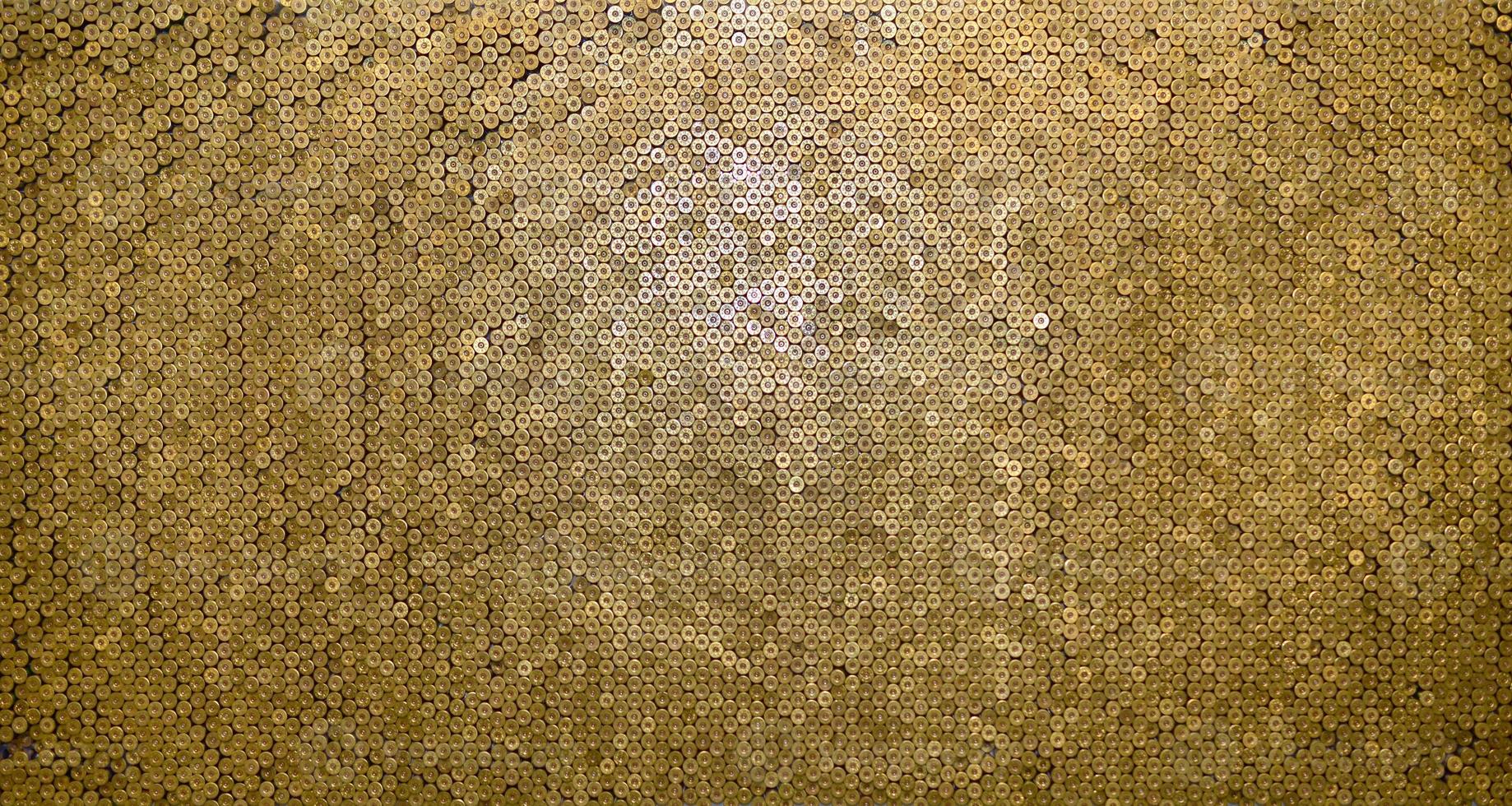 Pattern of 12 gauge cartridges for shotgun bullets. Shells for hunting rifle close up. Backdrop for shooting range or ammunition trade concepts photo