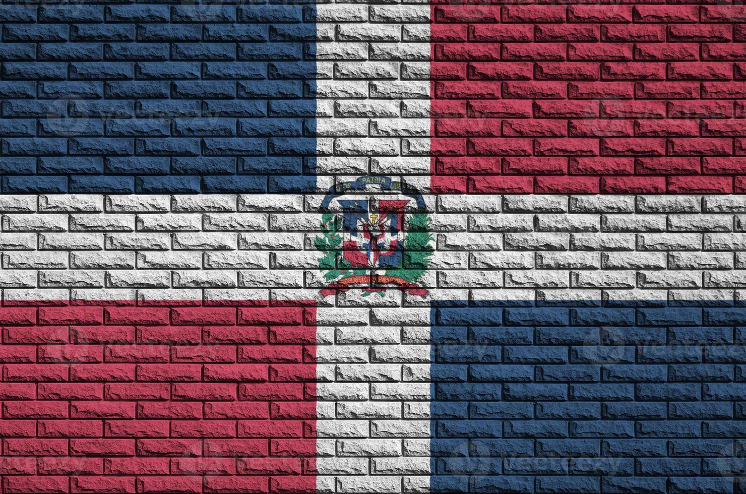 Dominican Republic flag is painted onto an old brick wall photo