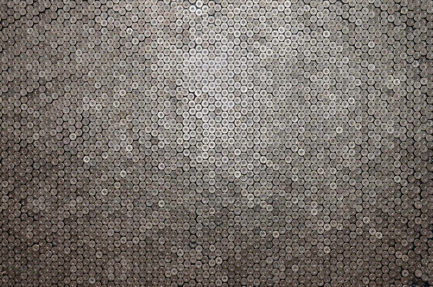 Pattern of 12 gauge cartridges for shotgun bullets. Shells for hunting rifle close up. Backdrop for shooting range or ammunition trade concepts photo