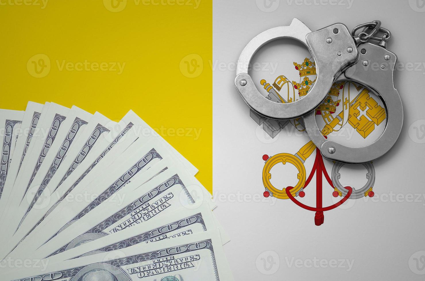 Vatican City State flag with handcuffs and a bundle of dollars. The concept of illegal banking operations in US currency photo