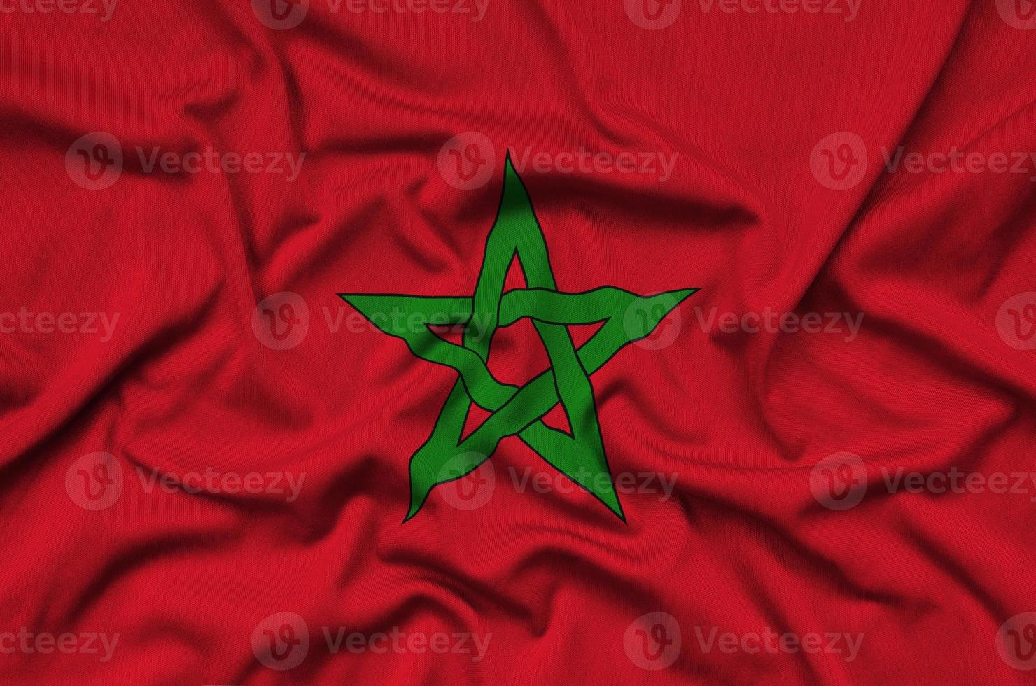 Morocco flag is depicted on a sports cloth fabric with many folds. Sport team banner photo