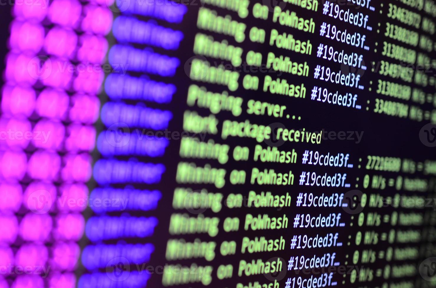 Macro snapshot of the program interface for crypto currency mining on the monitor of an office computer. The concept of mining bitcoins. The flow of information strings and data photo