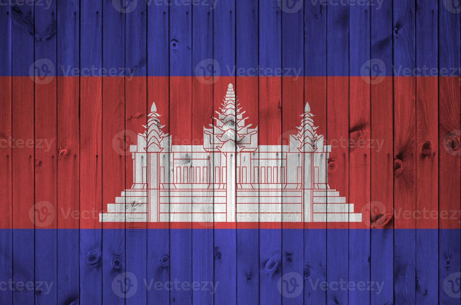 Cambodia flag depicted in bright paint colors on old wooden wall. Textured banner on rough background photo