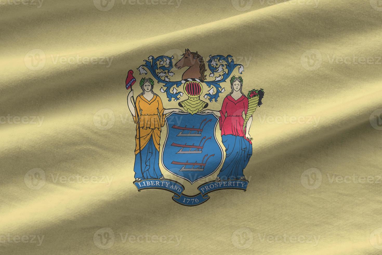 New Jersey US state flag with big folds waving close up under the studio light indoors. The official symbols and colors in banner photo